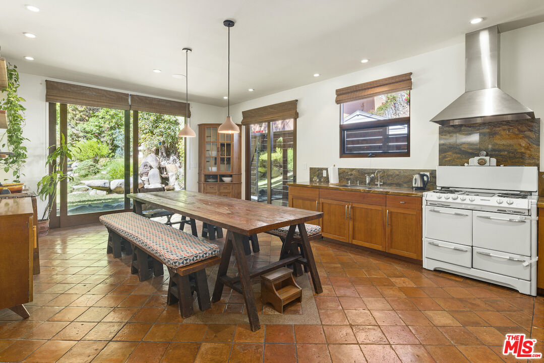 473 West Rustic Road Santa Monica, CA 90402 - Photo 7 of 25 a kitchen with a stove a sink a counter top space and living room view