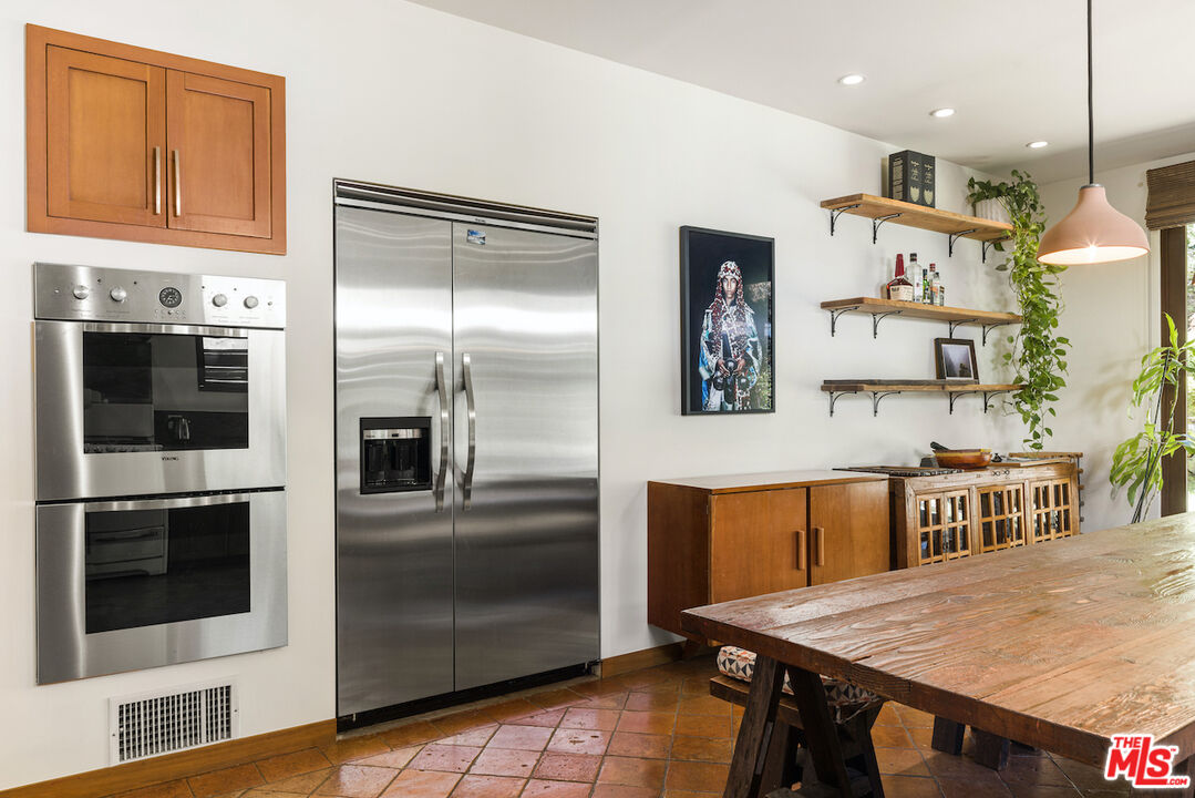 473 West Rustic Road Santa Monica, CA 90402 - Photo 9 of 25 a kitchen with stainless steel appliances granite countertop a refrigerator and a stove top oven