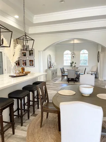 a view of a dining room with furniture and a chandelier