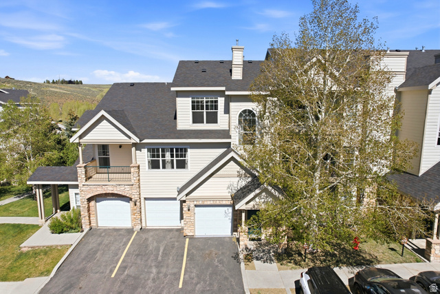 900 Bitner Road, Unit P20 Park City, UT 84098 - Photo 2 of 42 Multi-level townhome featuring stone accents, light-colored siding, multiple balconies, a two-car garage, and a steeply pitched roof
