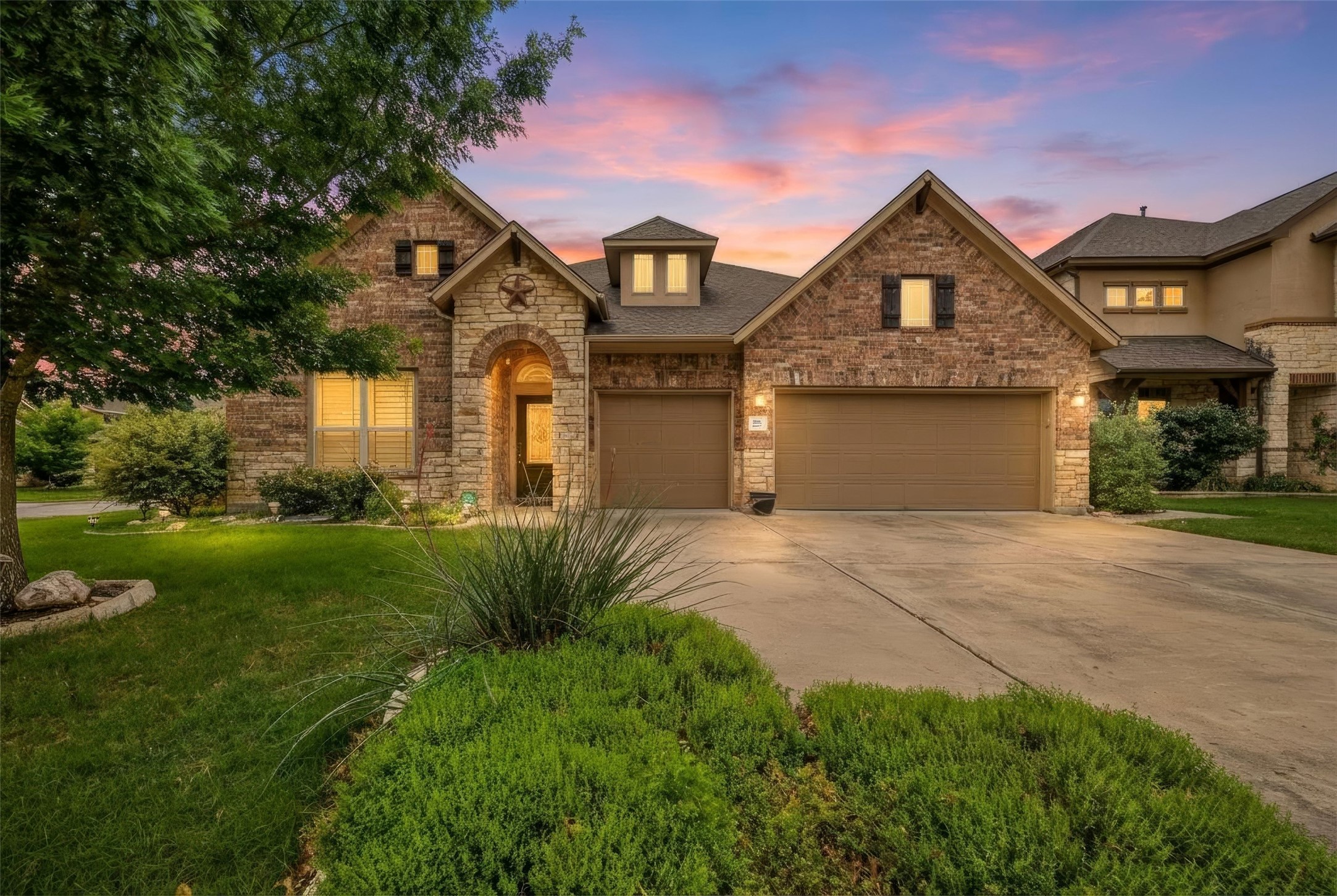 103 Lockhart Loop Georgetown, TX 78628 - Photo 1 of 1 View of front facade with roof with shingles, a yard, concrete driveway, an attached garage, and brick siding