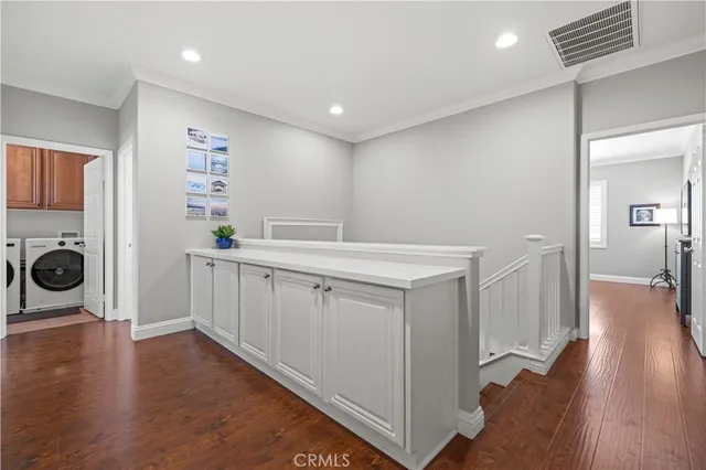 a hallway with a washer and dryer