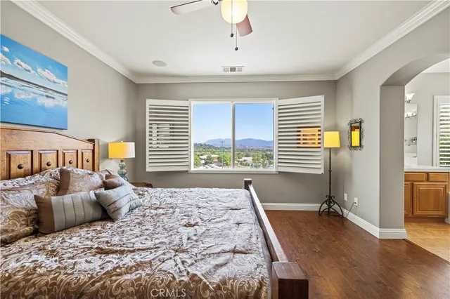 a bedroom with a large bed and a large window
