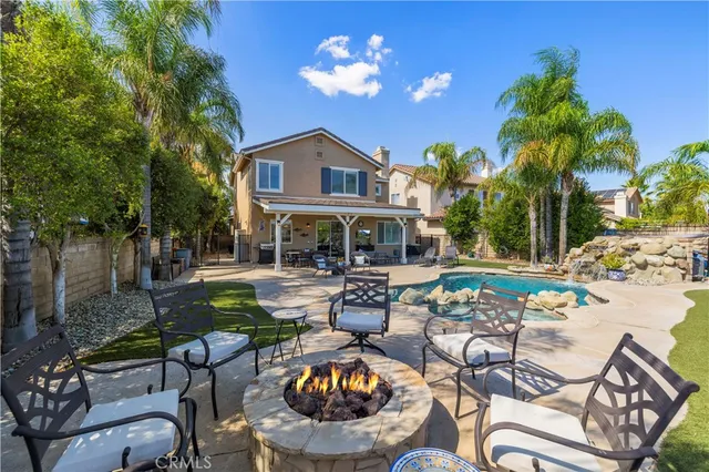 a view of a house with swimming pool and sitting area