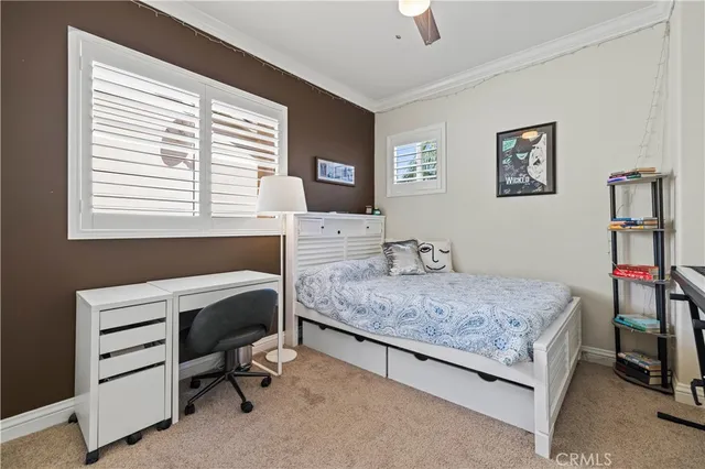 a bedroom that has a bed and a desk in it