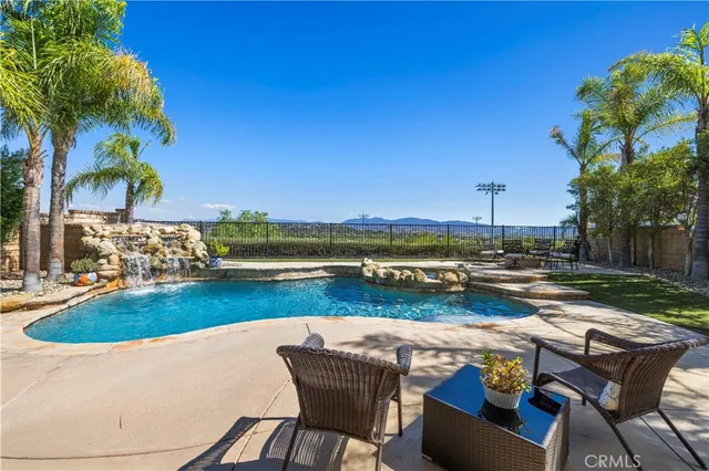 a view of swimming pool with outdoor seating