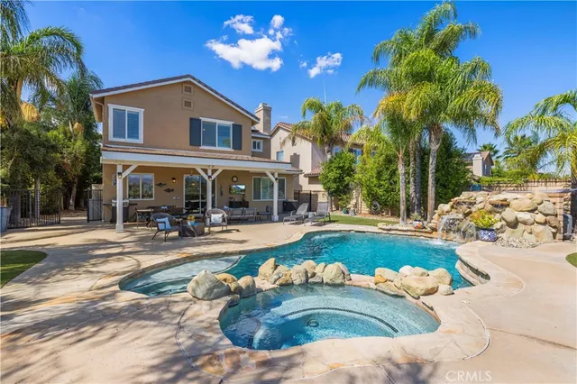 a front view of a house with swimming pool having outdoor seating