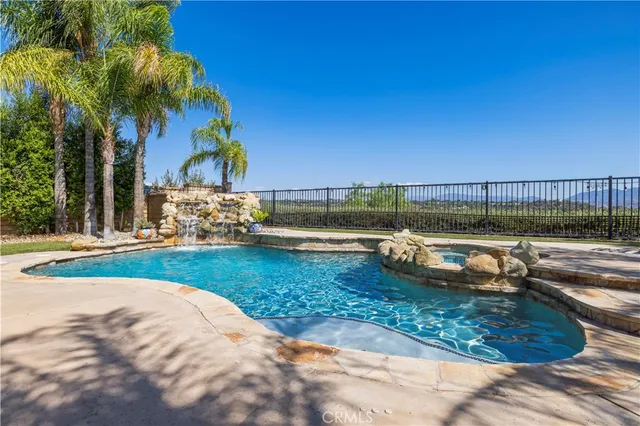 a view of a backyard with a table and chairs with wooden fence