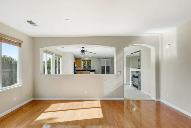 a view of a living room with furniture and large windows