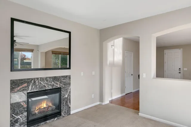 a view of a livingroom with a fireplace and a chandelier