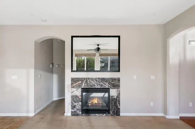 a living room with a fireplace and a potted plant