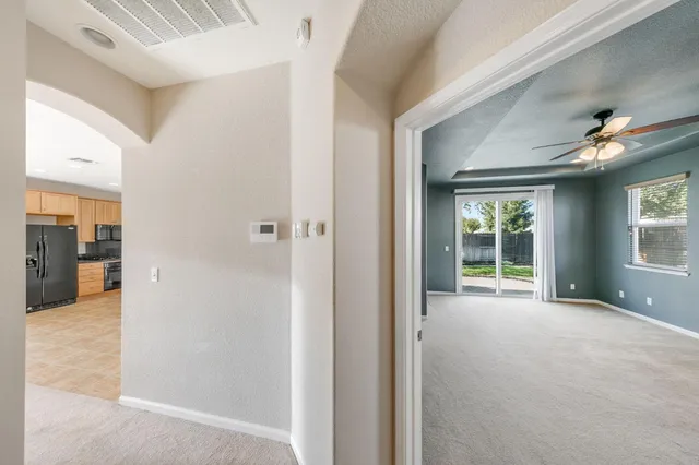 a view of a livingroom with a ceiling fan and window