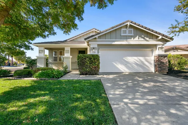 a front view of a house with garden