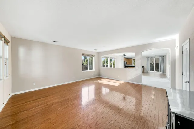 a view of a livingroom with wooden floor and a flat screen tv