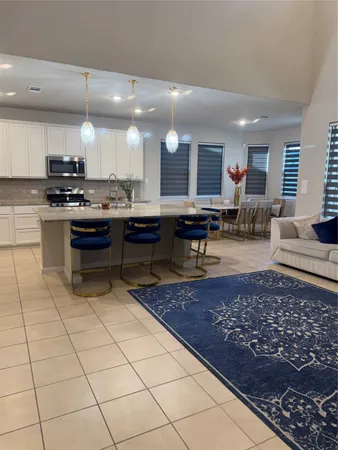 a kitchen with stainless steel appliances granite countertop a refrigerator sink and cabinets