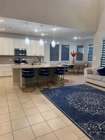 a kitchen with stainless steel appliances granite countertop a refrigerator sink and cabinets