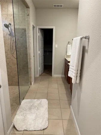 a view of a kitchen island with granite countertop a sink and cabinets