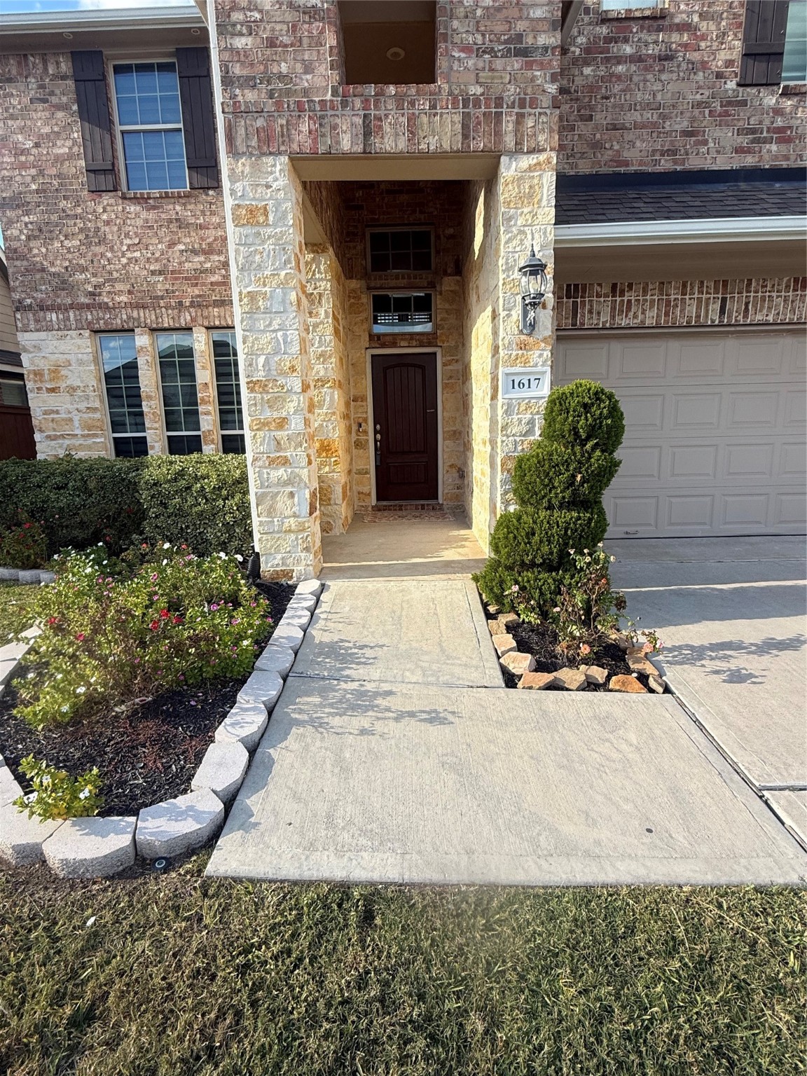1617 Darwin Cedar Drive Rosharon, TX 77583 - Photo 5 of 27 a front view of a building with potted plants