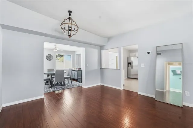 a view of a livingroom with hardwood floor and a ceiling fan