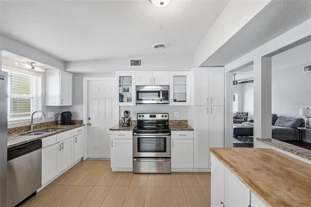 a kitchen with stainless steel appliances granite countertop a stove and a sink