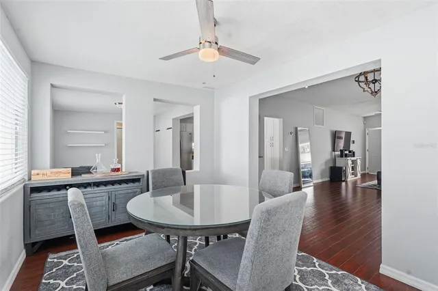 a view of a a dining room with furniture and wooden floor