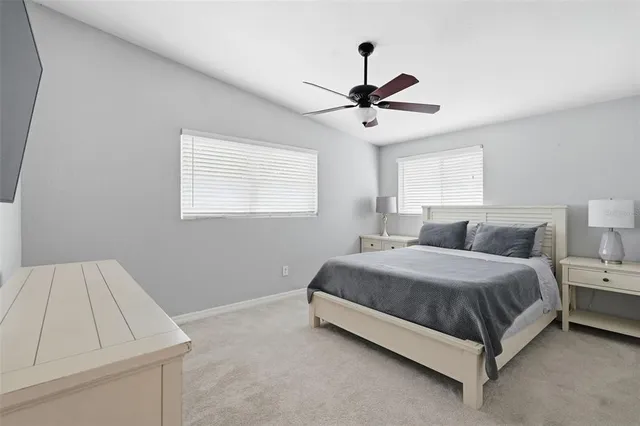a spacious bedroom with a bed and a window