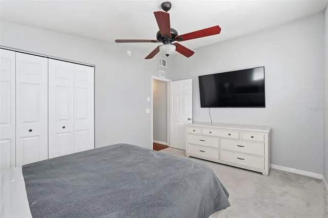 a living room with flat screen tv on the dresser
