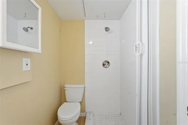a white toilet sitting next to a bathroom sink