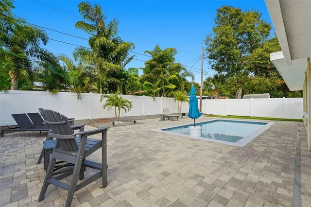 a view of a backyard with plants and a patio
