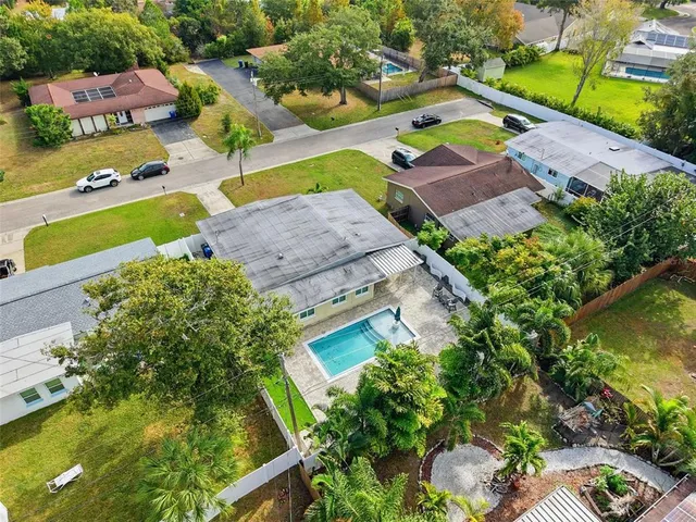 an aerial view of residential house with outdoor space and swimming pool