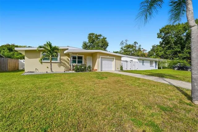 a house view with swimming pool in front of it