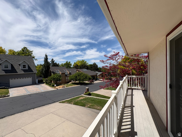595 Meadowlark Road Orem, UT 84097 - Photo 77 of 87 Exterior balcony featuring composite decking, white railing, and an adjacent sliding glass door