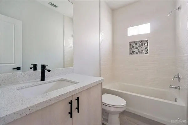 a bathroom with a sink a toilet and a bathtub