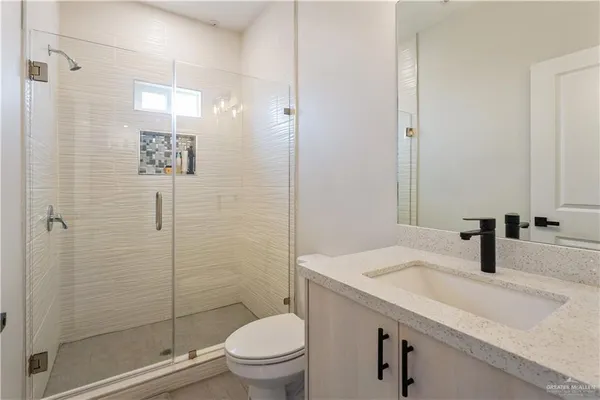a bathroom with a sink toilet and shower