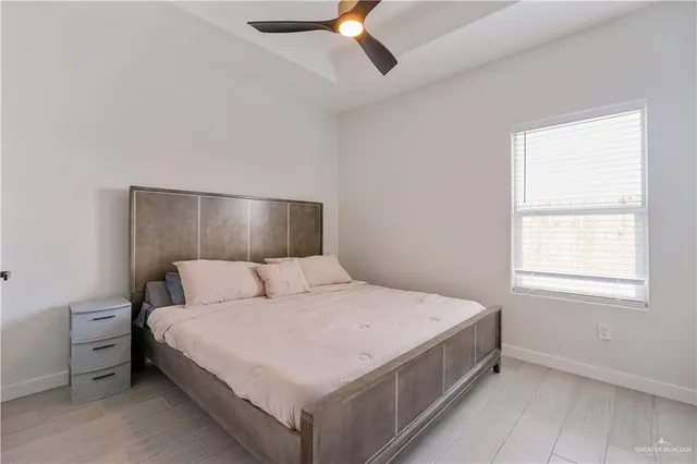 a large bed sitting in a bedroom next to a window