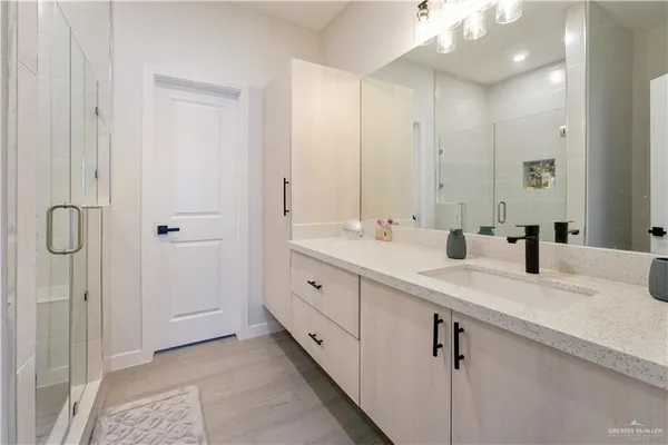 a spacious bathroom with a granite countertop sink and a mirror