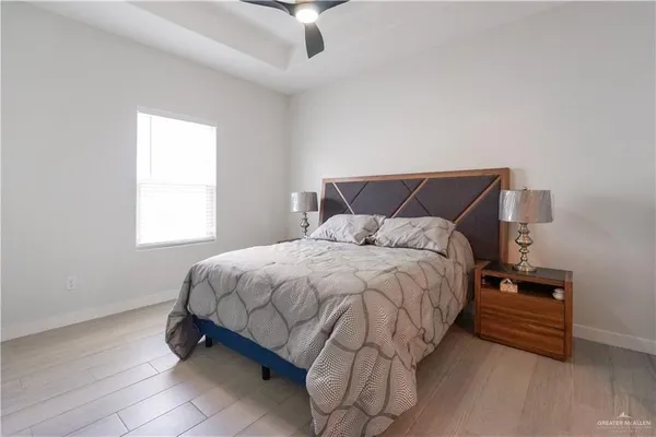 a bedroom with a bed and a ceiling fan