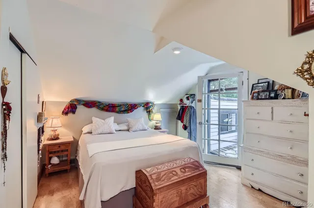 a bathroom with a granite countertop sink a toilet a mirror and shower