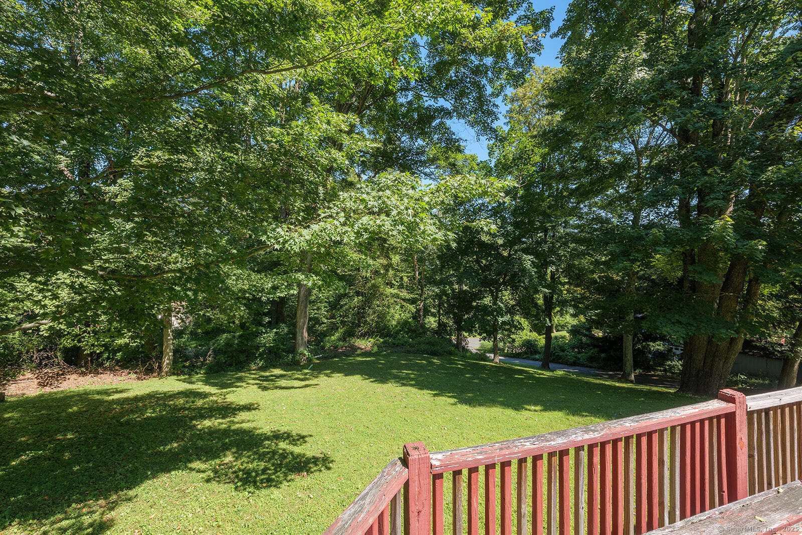 26 Wilridge Road Ridgefield, CT 06877 - Photo 13 of 40 a view of a wooden deck and a yard