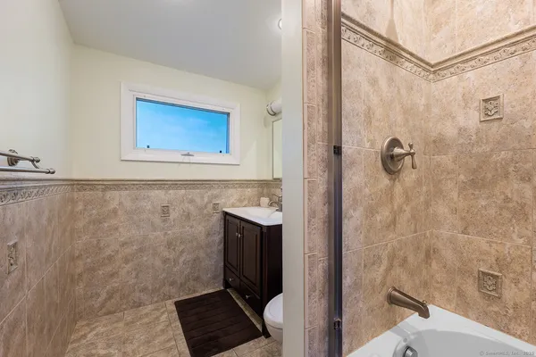 a view of a room with wooden floor and a sink