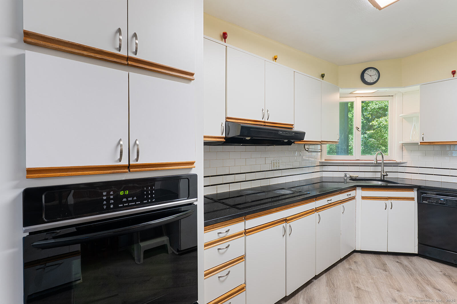 26 Wilridge Road Ridgefield, CT 06877 - Photo 22 of 40 a kitchen with stainless steel appliances a stove a sink and cabinets