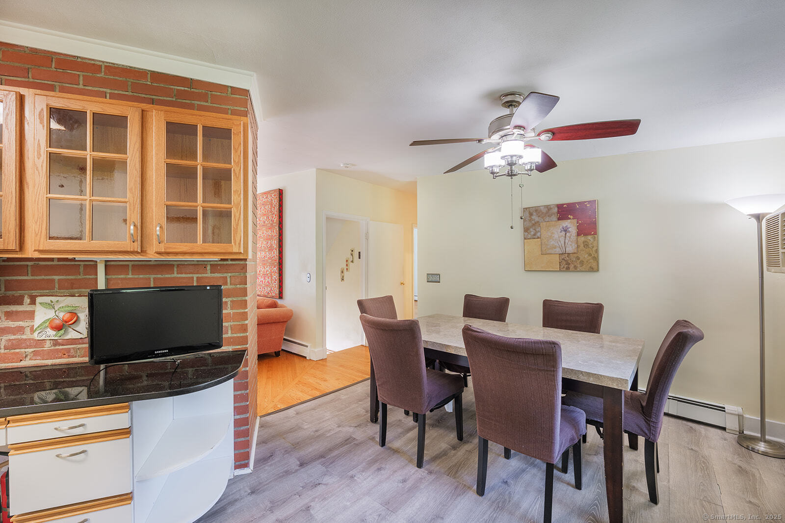 26 Wilridge Road Ridgefield, CT 06877 - Photo 23 of 40 a view of a dining room with furniture a chandelier and wooden floor