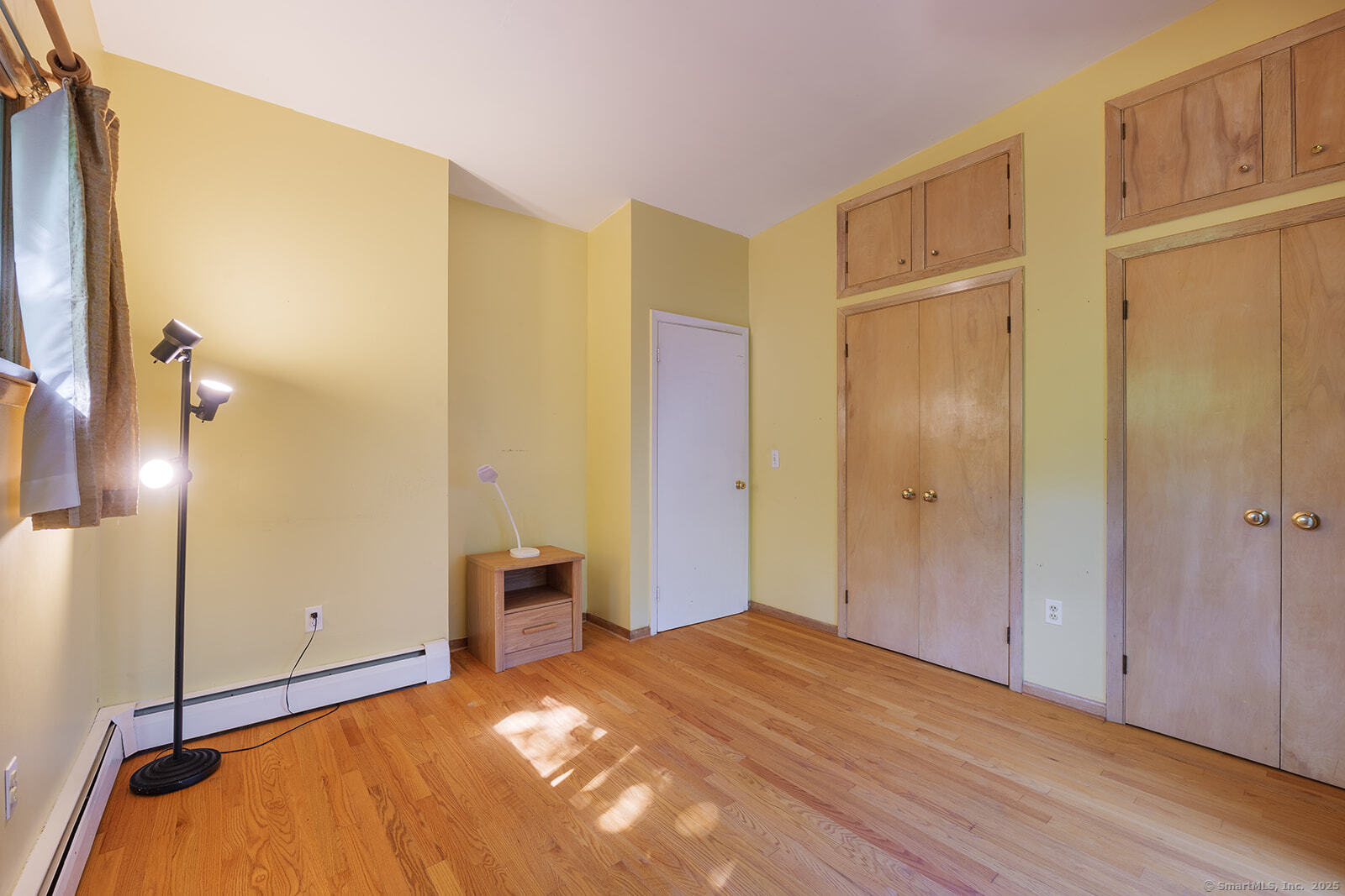 26 Wilridge Road Ridgefield, CT 06877 - Photo 26 of 40 a bedroom with a bed and cabinets