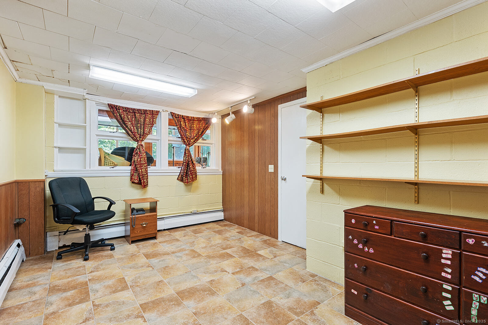 26 Wilridge Road Ridgefield, CT 06877 - Photo 29 of 40 a bedroom with a bed and a chandelier