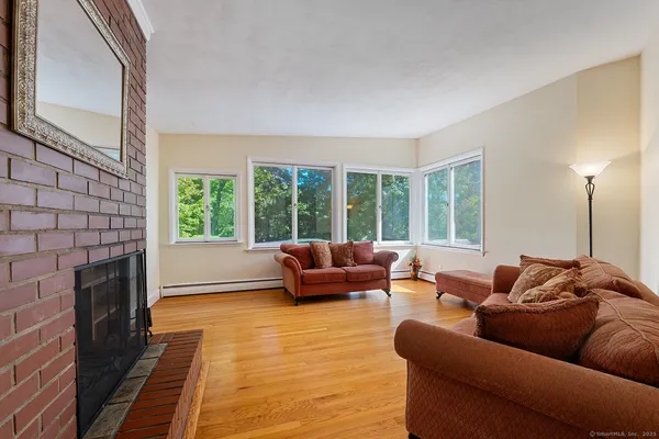 a living room with furniture and a fireplace