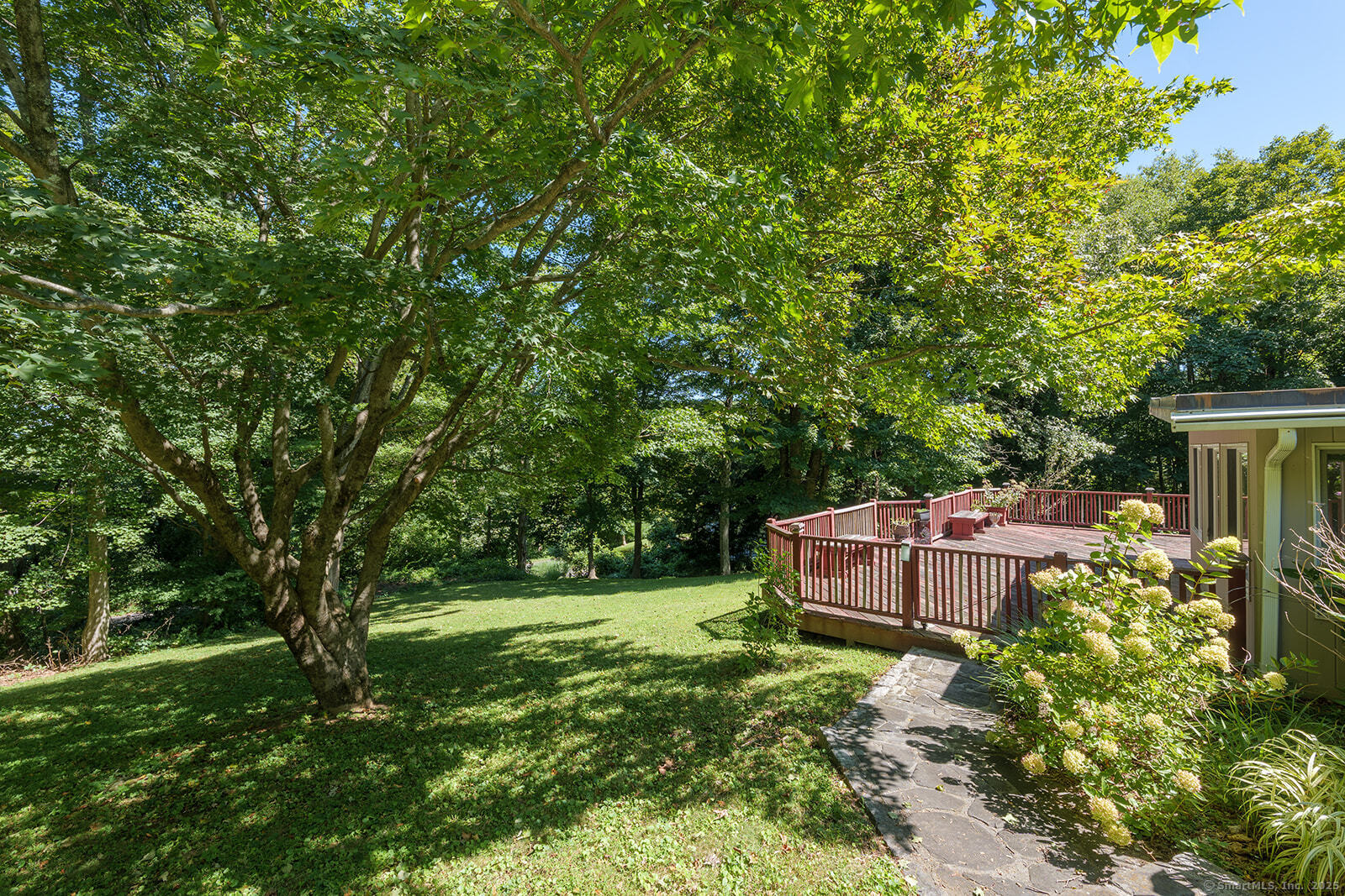 26 Wilridge Road Ridgefield, CT 06877 - Photo 8 of 40 a backyard of a house with a garden and deck