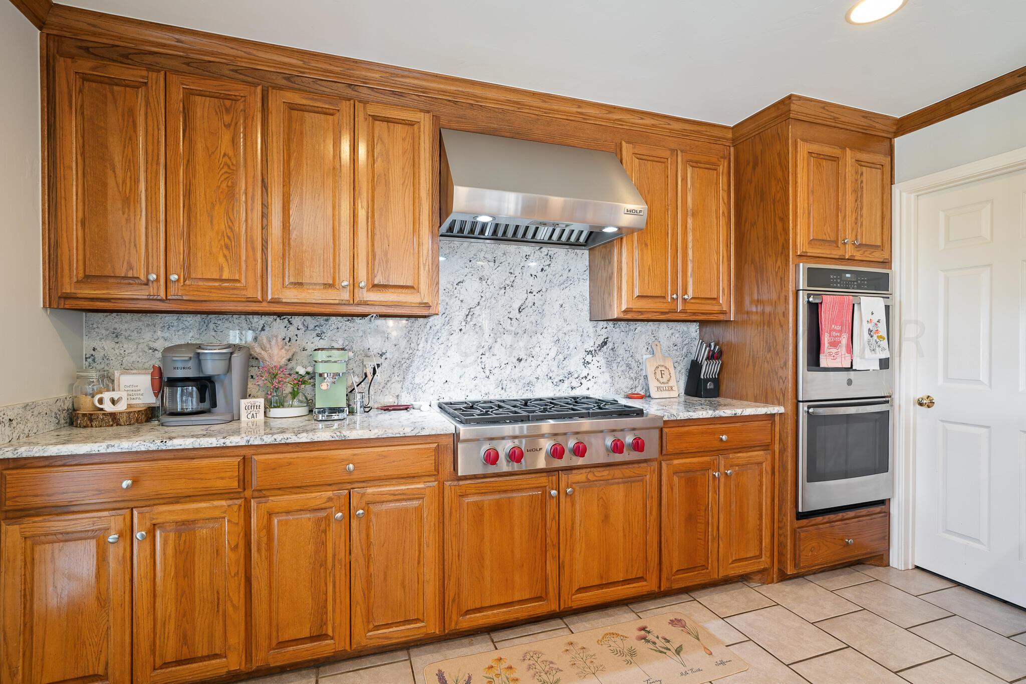 327 Lake Ridge Road Canyon, TX 79015 - Photo 11 of 38 a kitchen with stainless steel appliances granite countertop a sink stove and cabinets