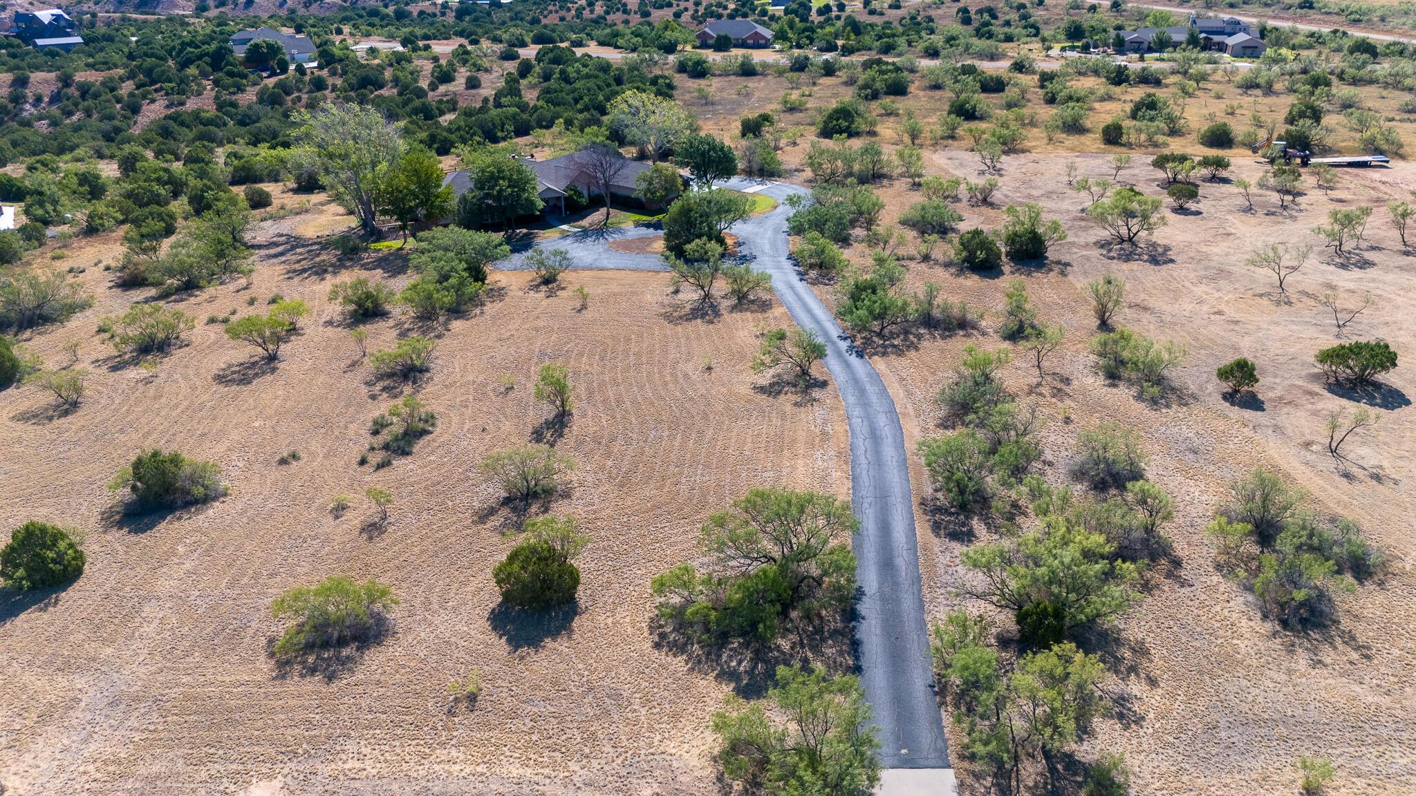 327 Lake Ridge Road Canyon, TX 79015 - Photo 37 of 38 an aerial view of a house with a yard