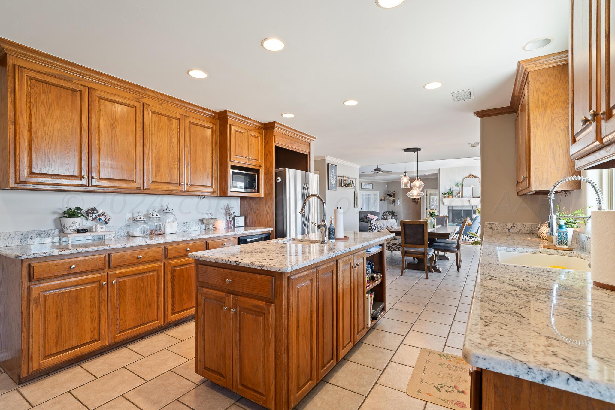 327 Lake Ridge Road Canyon, TX 79015 - Photo 10 of 38 a kitchen with a sink and cabinets