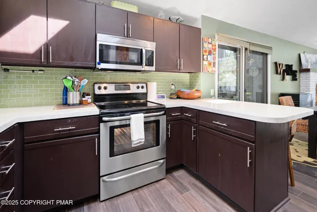 a kitchen with a sink stove and microwave